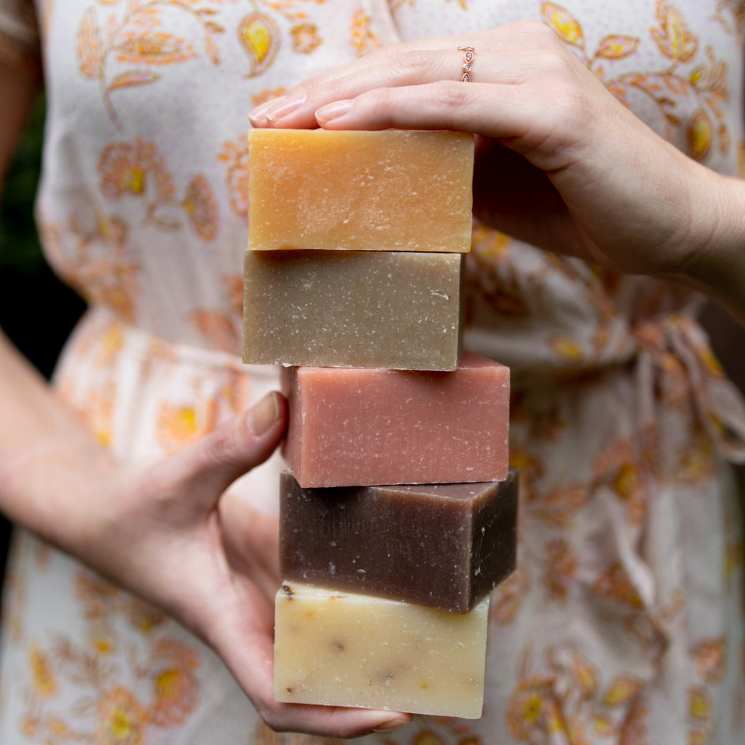 photo of a woman holding a stack of bar soaps